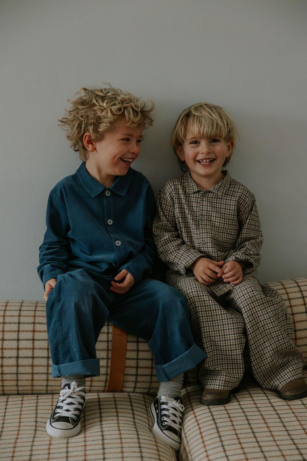 Boy wearing Lalaby Frankie pants for kids in tweedy check organic cotton