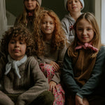 Boy wearing Lalaby Hugo v-neck for kids in a millet brown baby wool, yak and cashnere blend