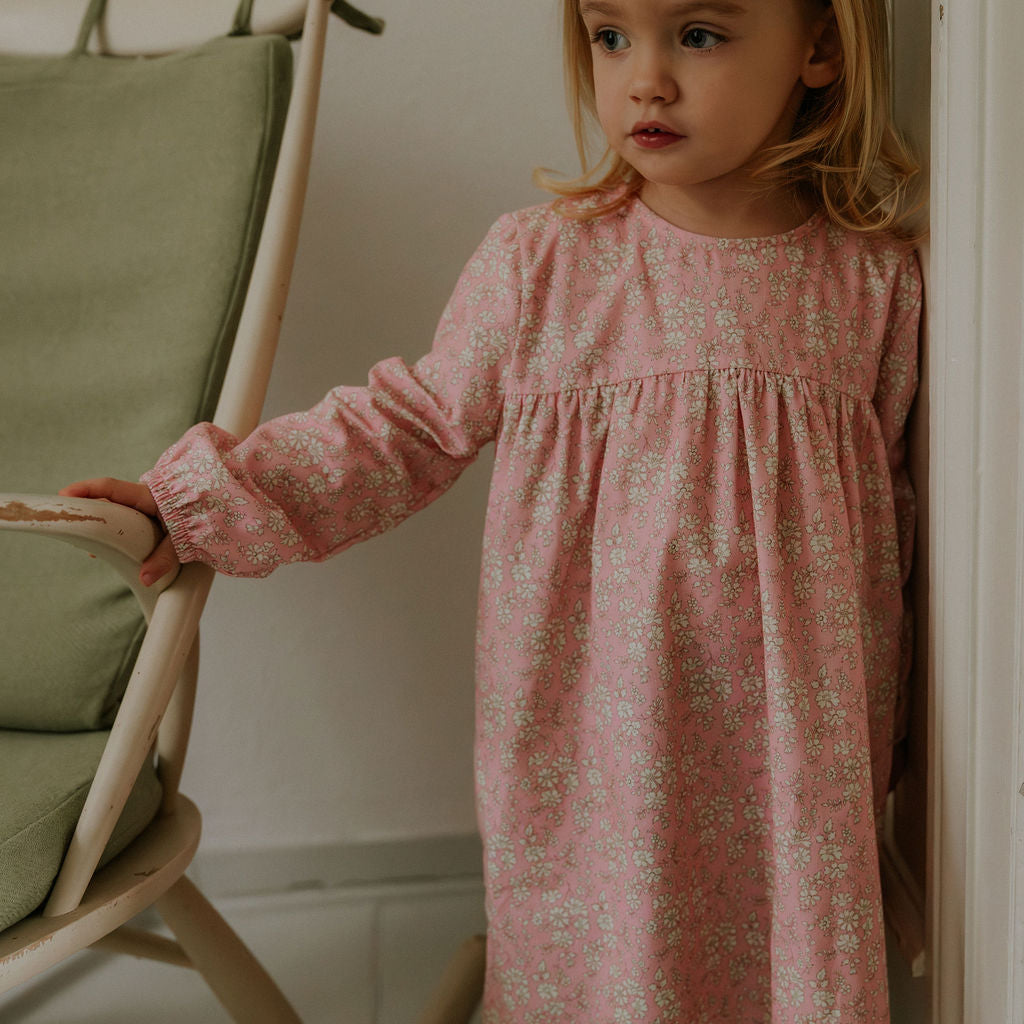 Girl wearing Lalaby Ines dress for kids in pink flower liberty cotton corduroy 