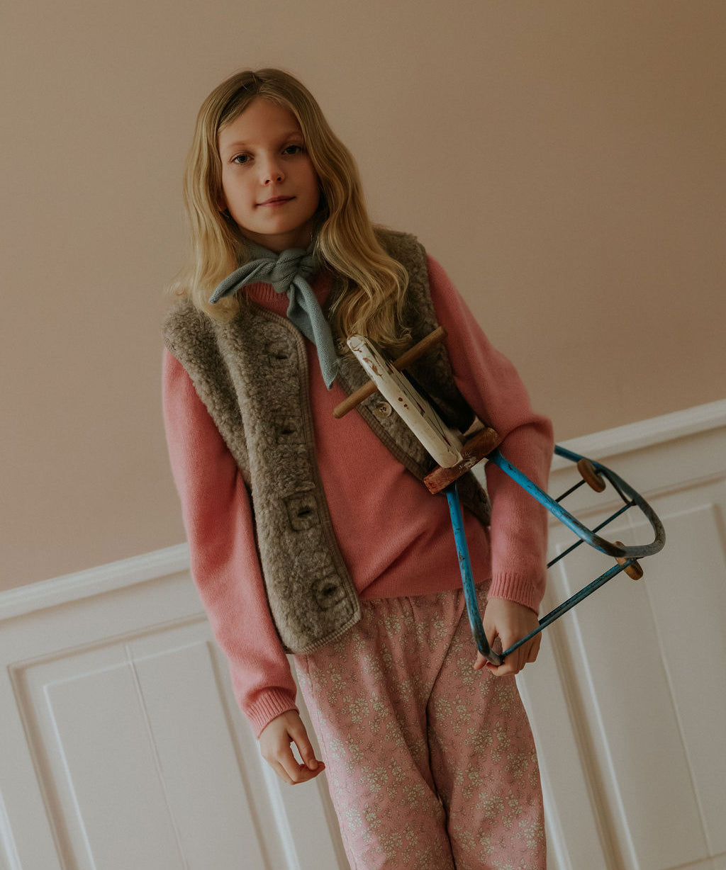 Girl wearing Lalaby Ivalo vest for kids in grizzly brown merino wool
