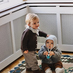 Baby boy wearing Lalaby Kuro cardigan for babies in chocolate brown merino wool