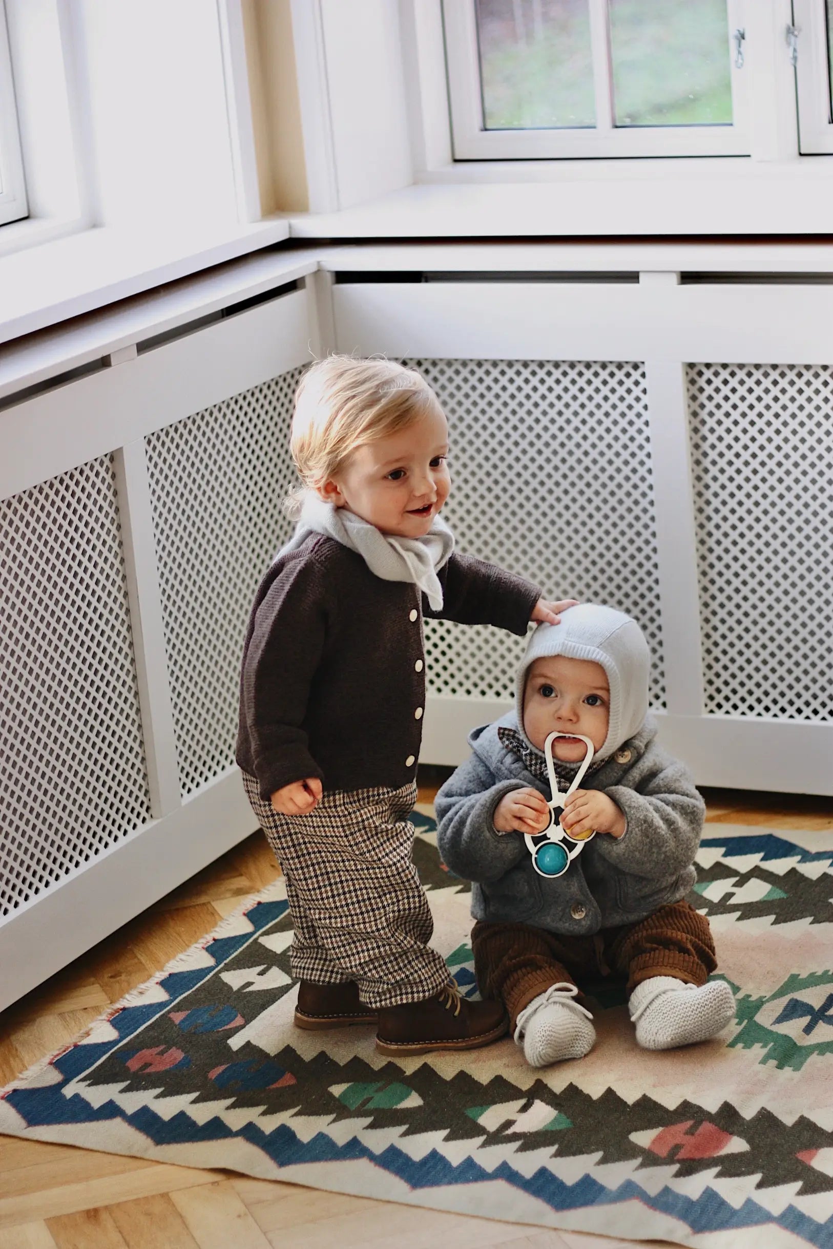 Baby boy wearing Lalaby Kuro cardigan for babies in chocolate brown merino wool