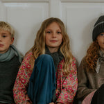 Girl wearing Lalaby Mimi kids shirt in berry betsy pink liberty organic cotton