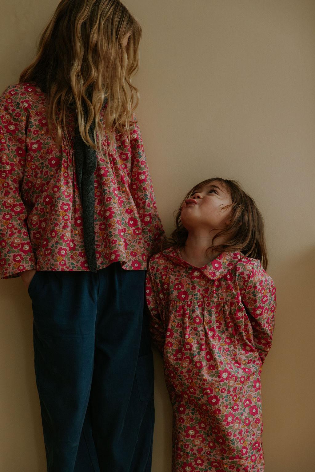 Girl wearing Lalaby Mimi kids shirt in berry betsy pink liberty organic cotton