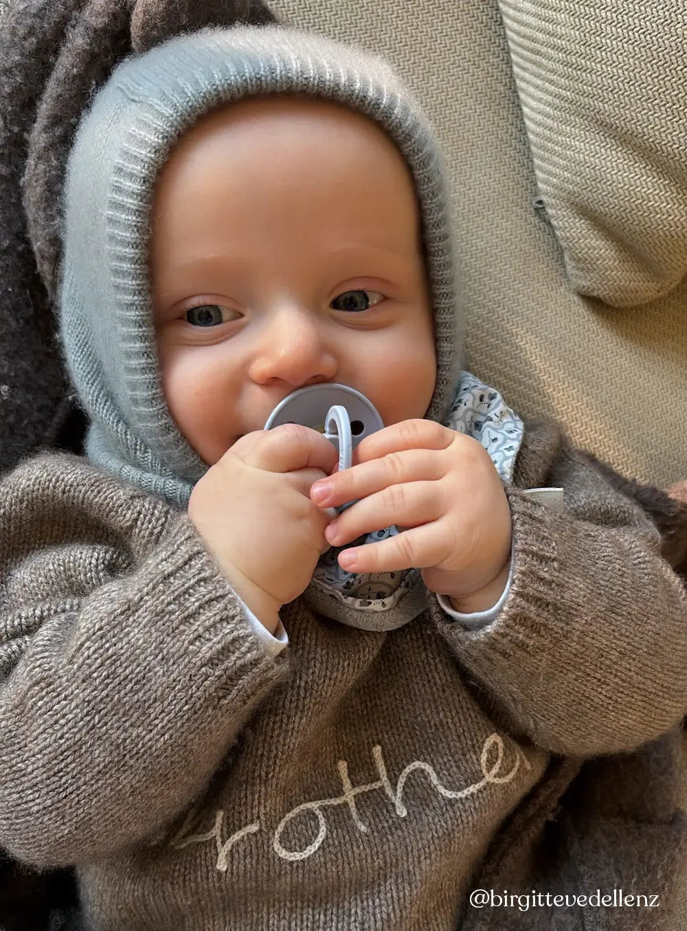 Baby wearing Lalaby Mio balaclava in dove blue cashmere