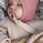 Baby wearing Lalaby Mio balaclava in sorbet pink cashmere