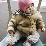 Baby wearing Lalaby Mio balaclava in sorbet pink cashmere