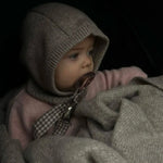 Baby wearing Lalaby Mio balaclava in toast brown cashmere