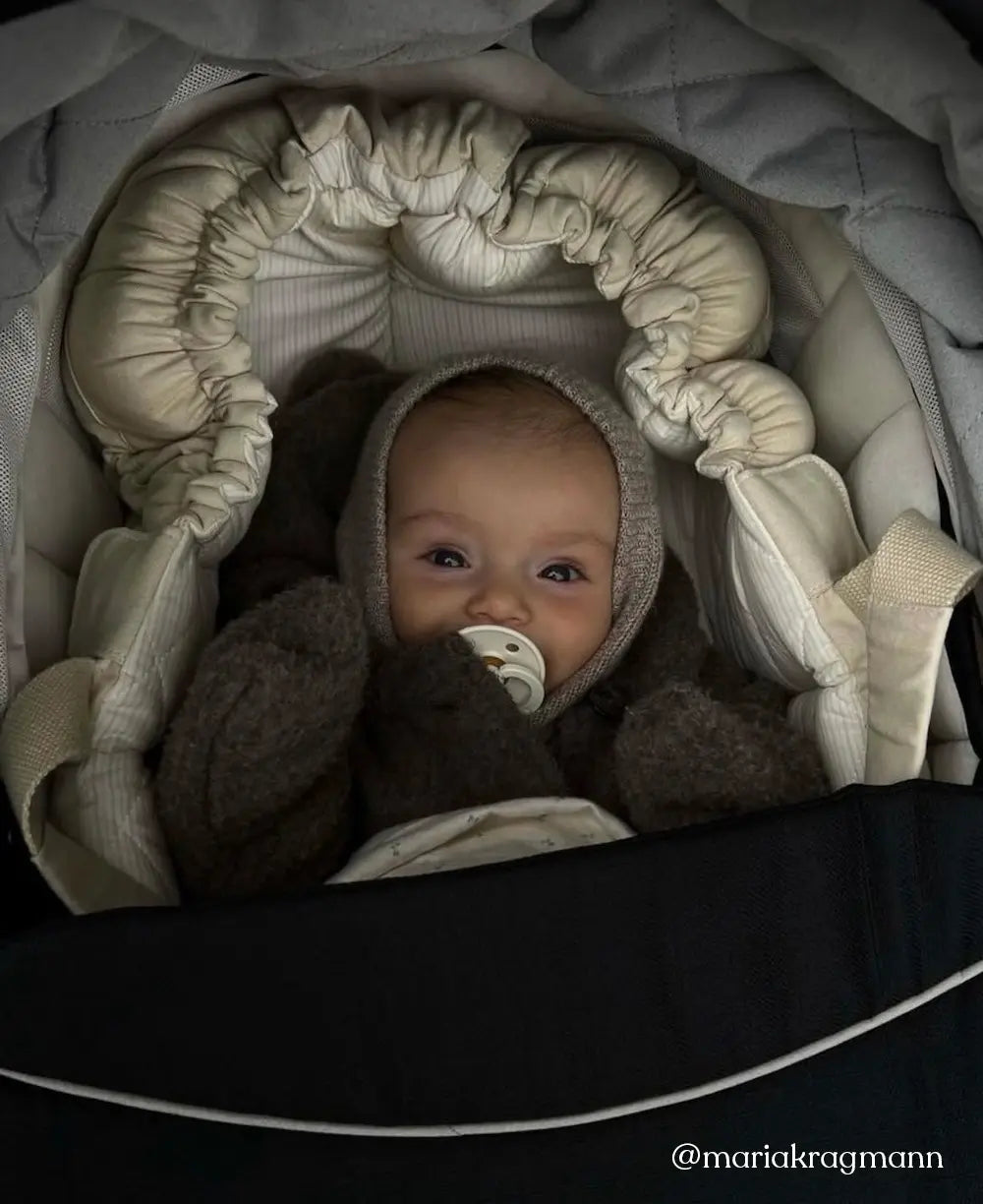 Baby wearing Lalaby Mio balaclava in toast brown cashmere