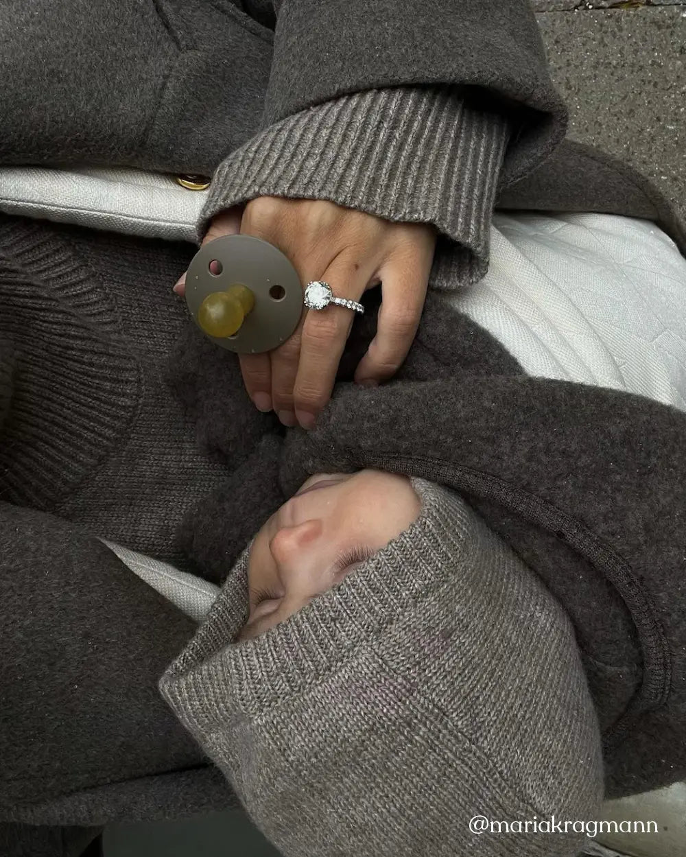 Baby wearing Lalaby Mio balaclava in toast brown cashmere