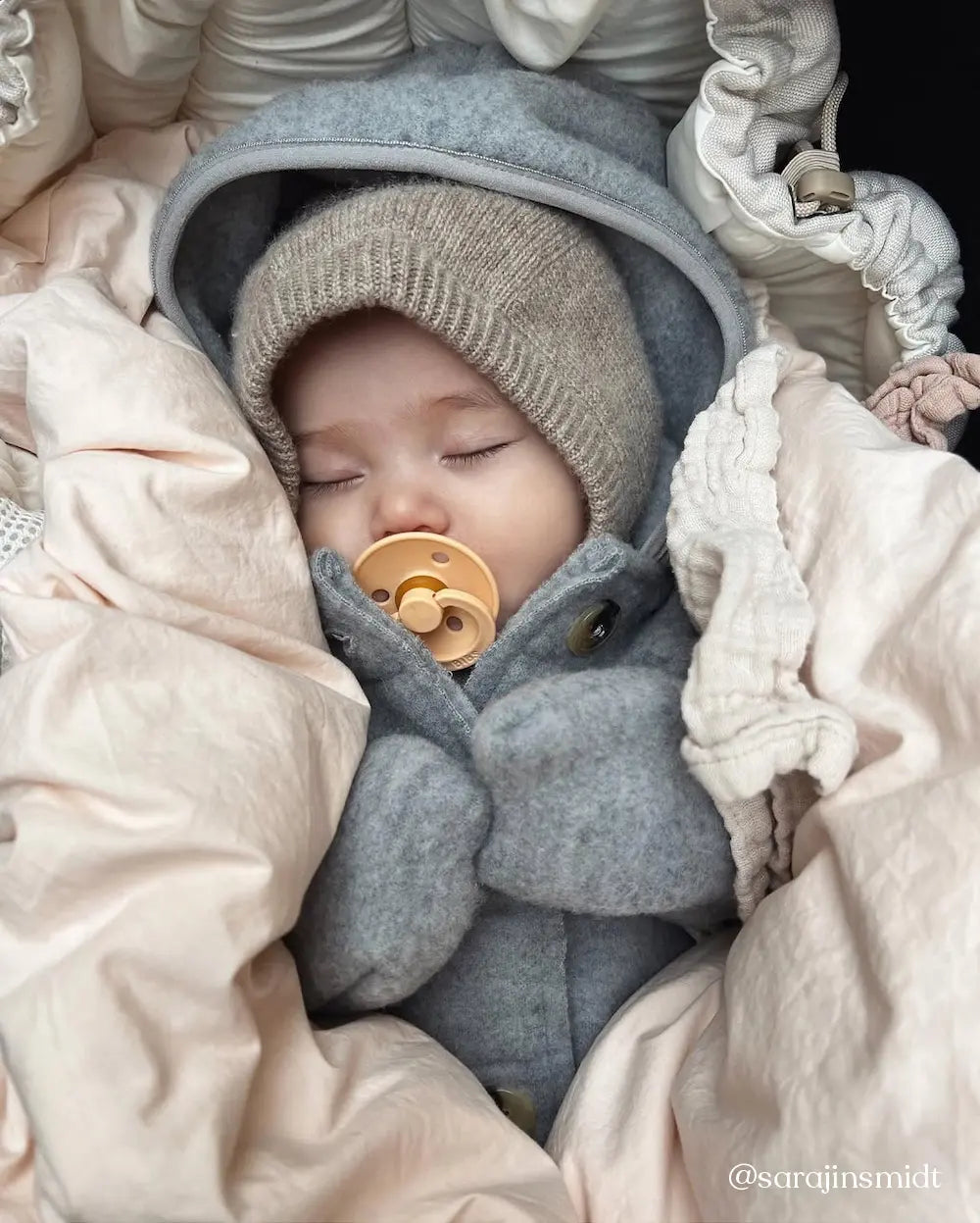 Baby wearing Lalaby Mio balaclava in toast brown cashmere