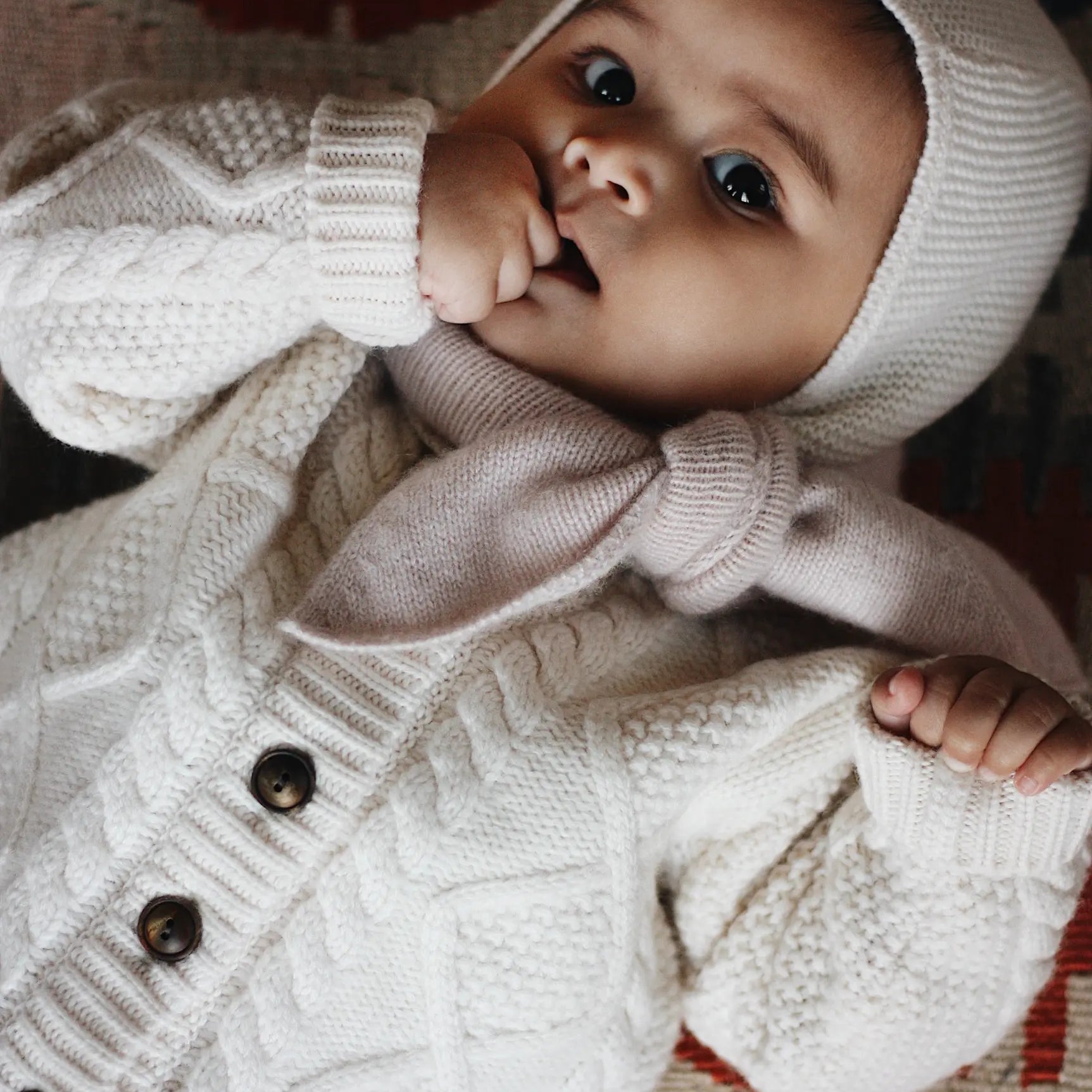 Baby girl wearing Lalaby Mumi balaclava for babies and kids in natural white merino wool