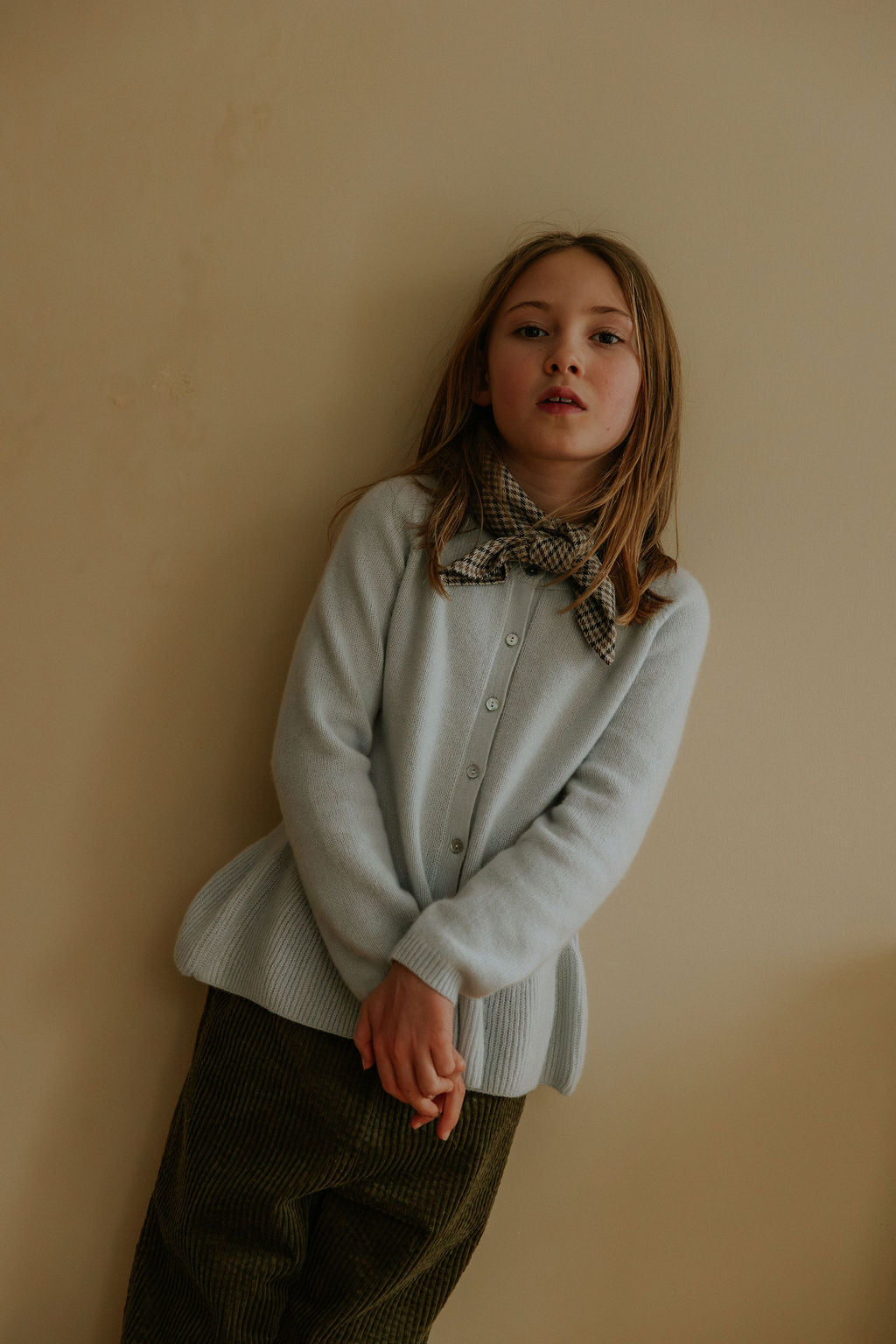 Girl wearing Lalaby Oda cardigan in bluey light blue cashmere