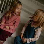 Girl wearing Lalaby Oda cardigan in sorbet pink cashmere