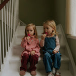 Girl wearing Lalaby Oda cardigan in sorbet pink cashmere