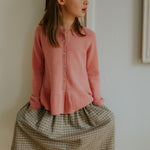 Girl wearing Lalaby Oda cardigan in sorbet pink cashmere