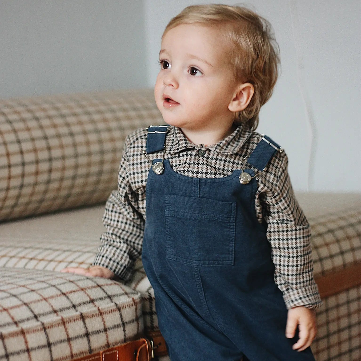 Baby boy wearing Lalaby Ole overalls for babies and kids in whale blue cotton baby corduroy