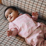 Baby girl wearing Lalaby Oya baby top in pink flower cotton liberty corduroy 