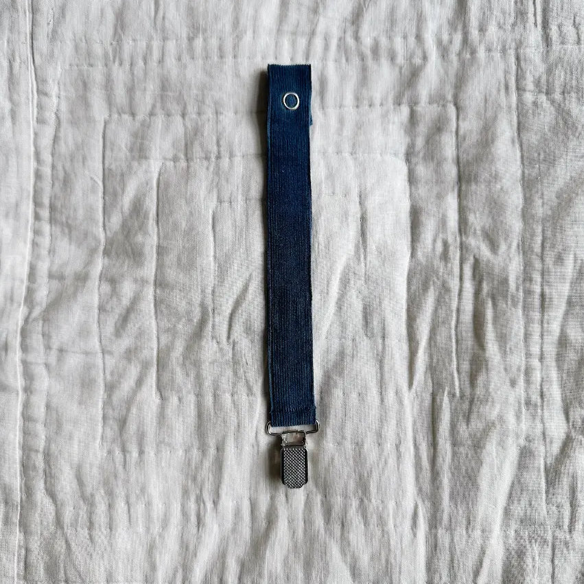 Lalaby pacifier clip in whale blue cotton baby cord with a metal clip for attachment  