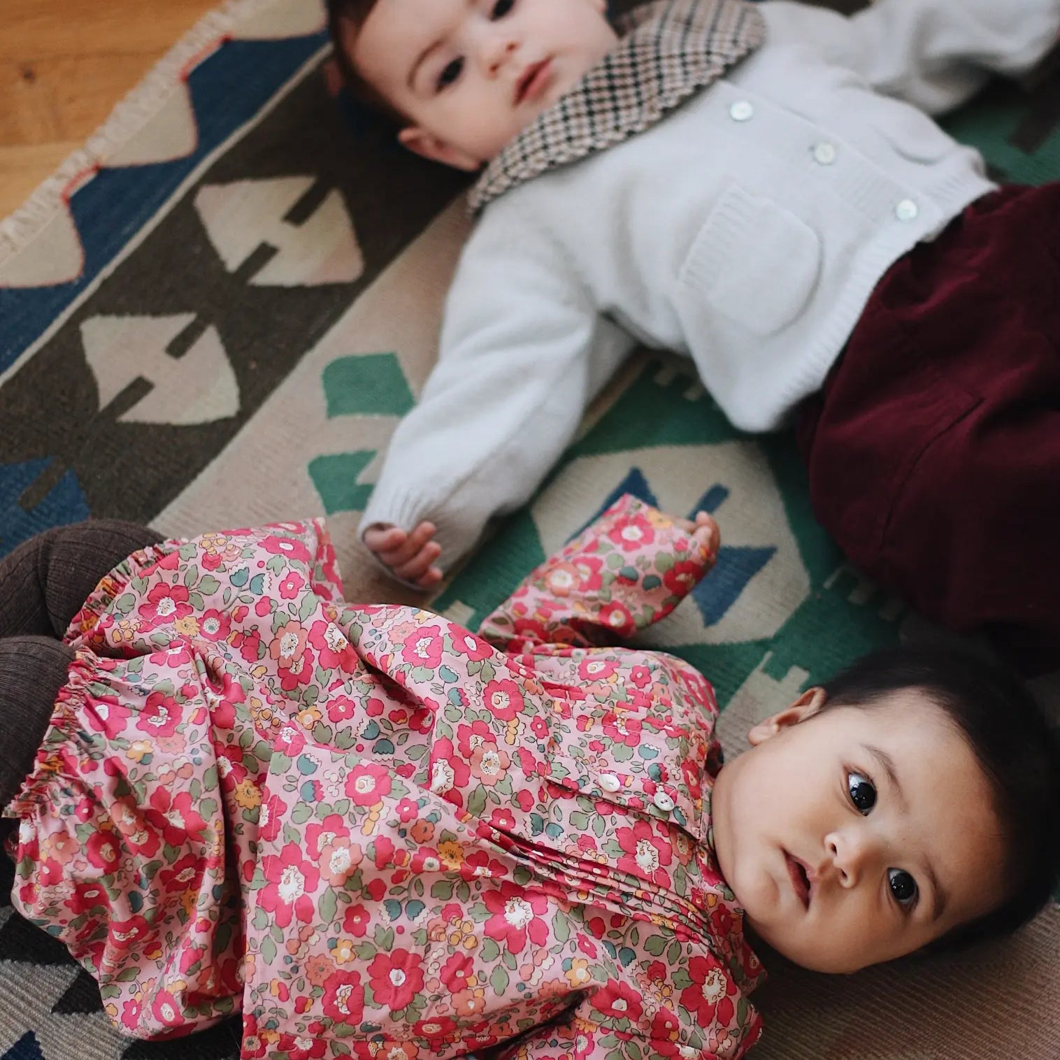 Baby boy wearing Lalaby Pixi pants for babies in ruby red cotton baby cord