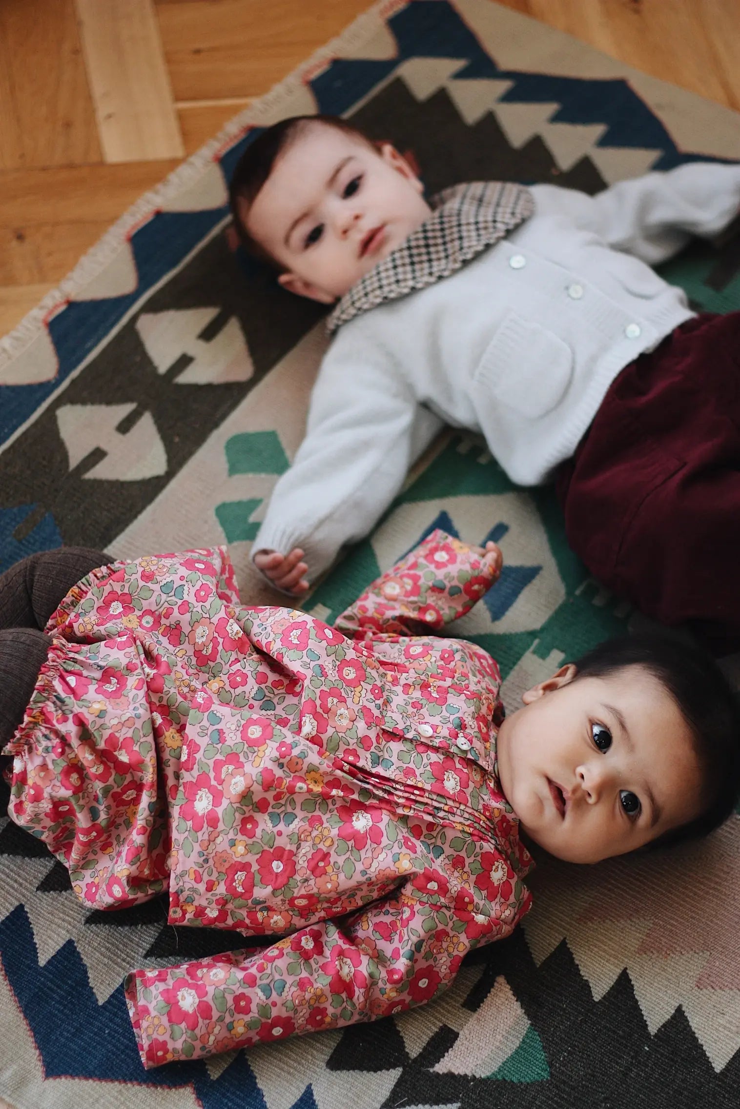 Baby boy wearing Lalaby Pixi pants for babies in ruby red cotton baby cord