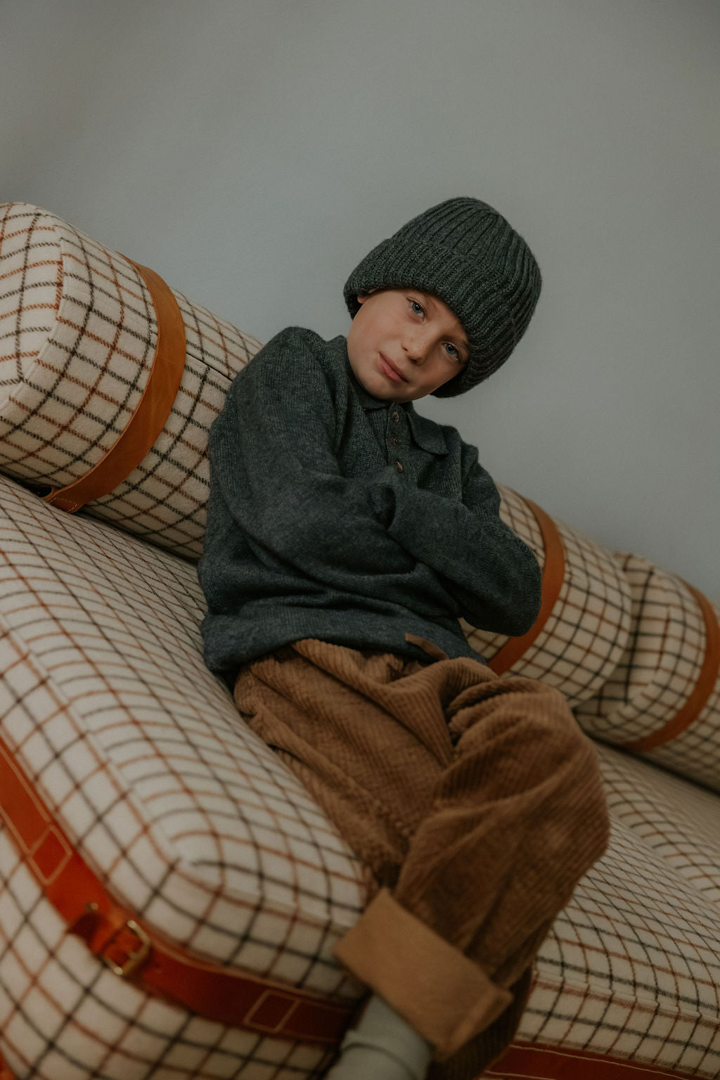 Boy wearing Lalaby Pauli polo in storm grey cashmere