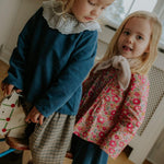 Girl wearing Lalaby Petra skirt for kids in whale blue cotton baby cord