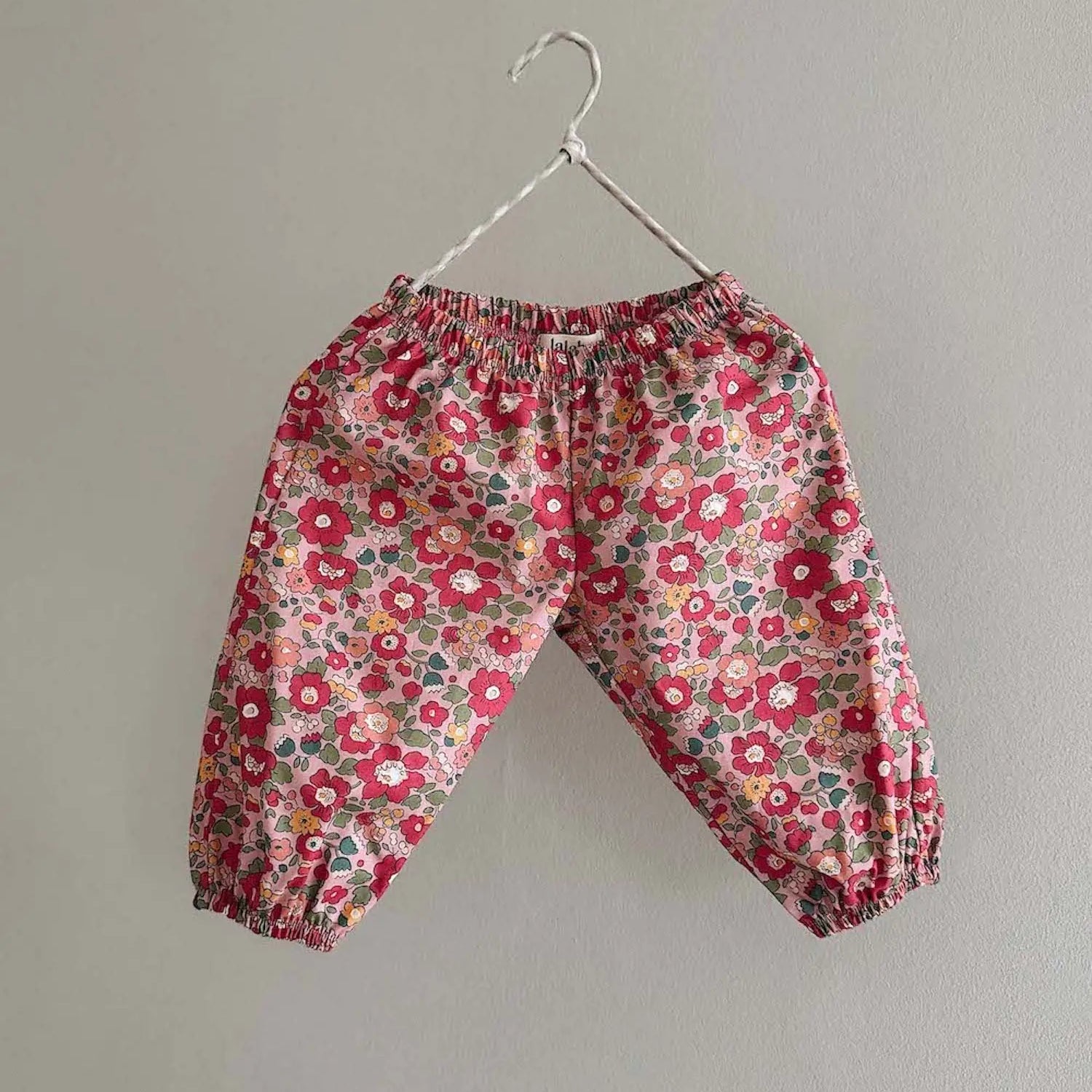 Lalaby Pixi pants for babies in berry betsy pink liberty organic cotton