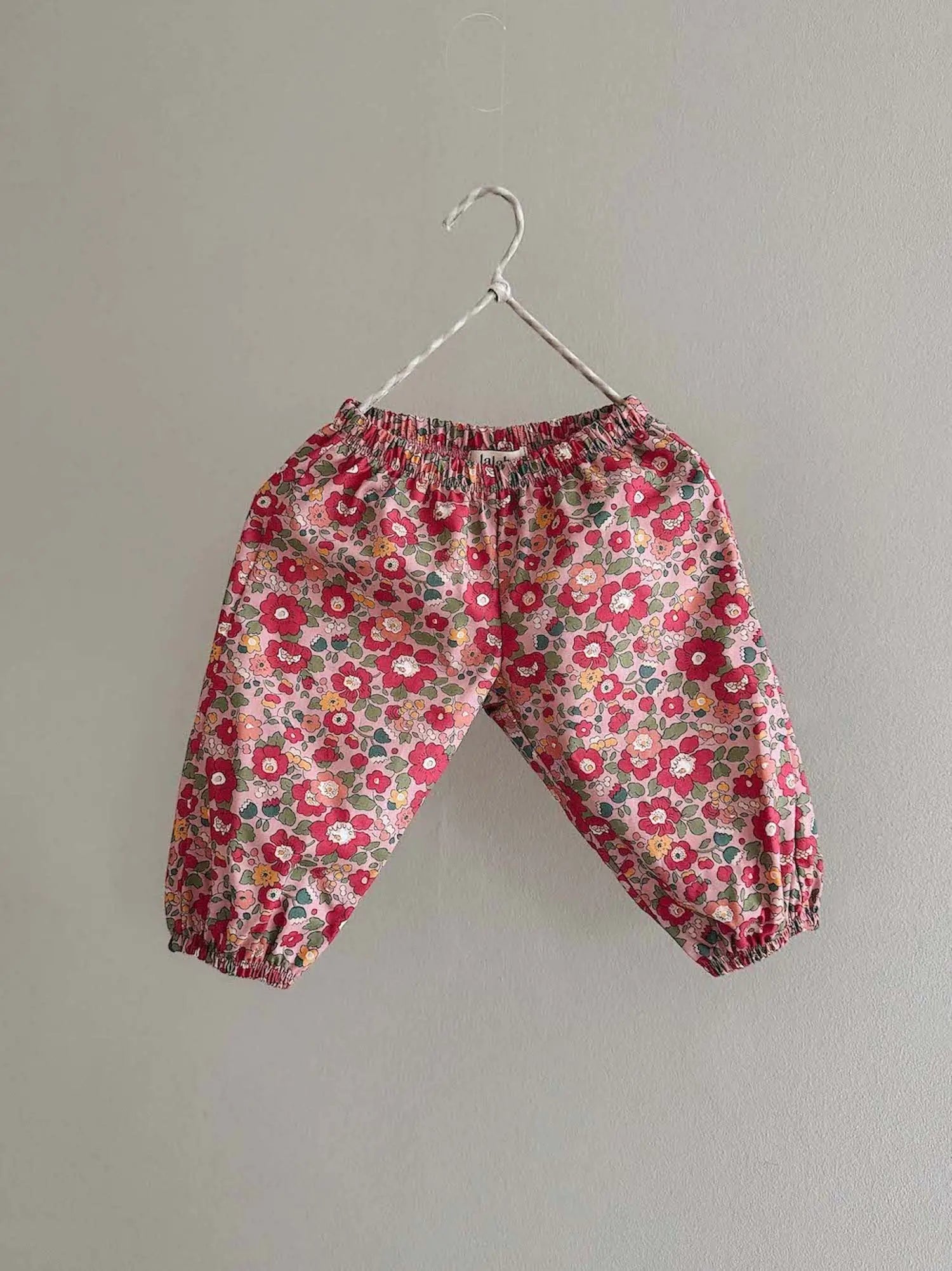 Lalaby Pixi pants for babies in berry betsy pink liberty organic cotton