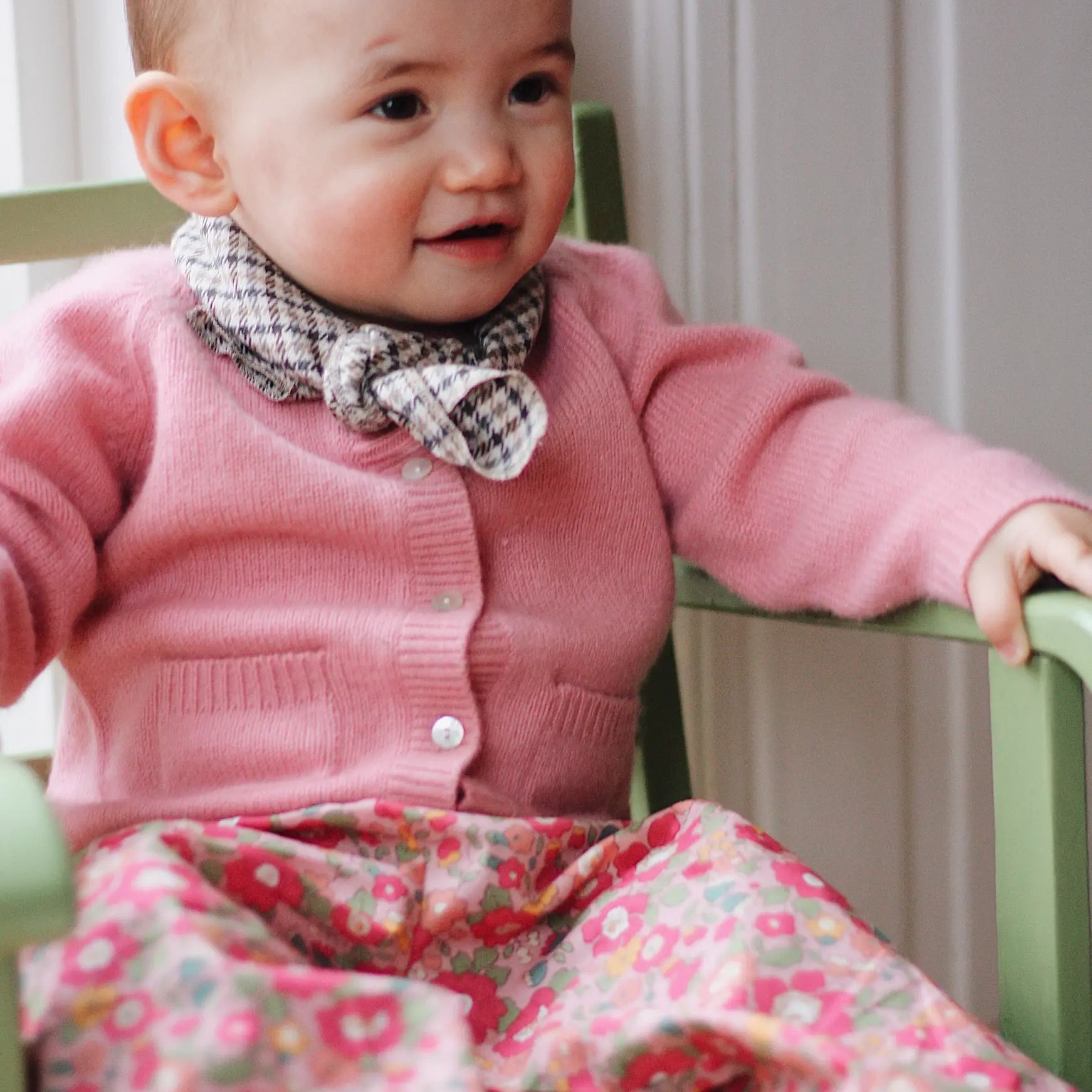 Baby girl wearing Lalaby Pixi baby pants in Berry besty pink liberty organic cotton