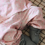 Baby girl wearing Lalaby Pixi pants for babies in pink flower liberty cotton corduroy