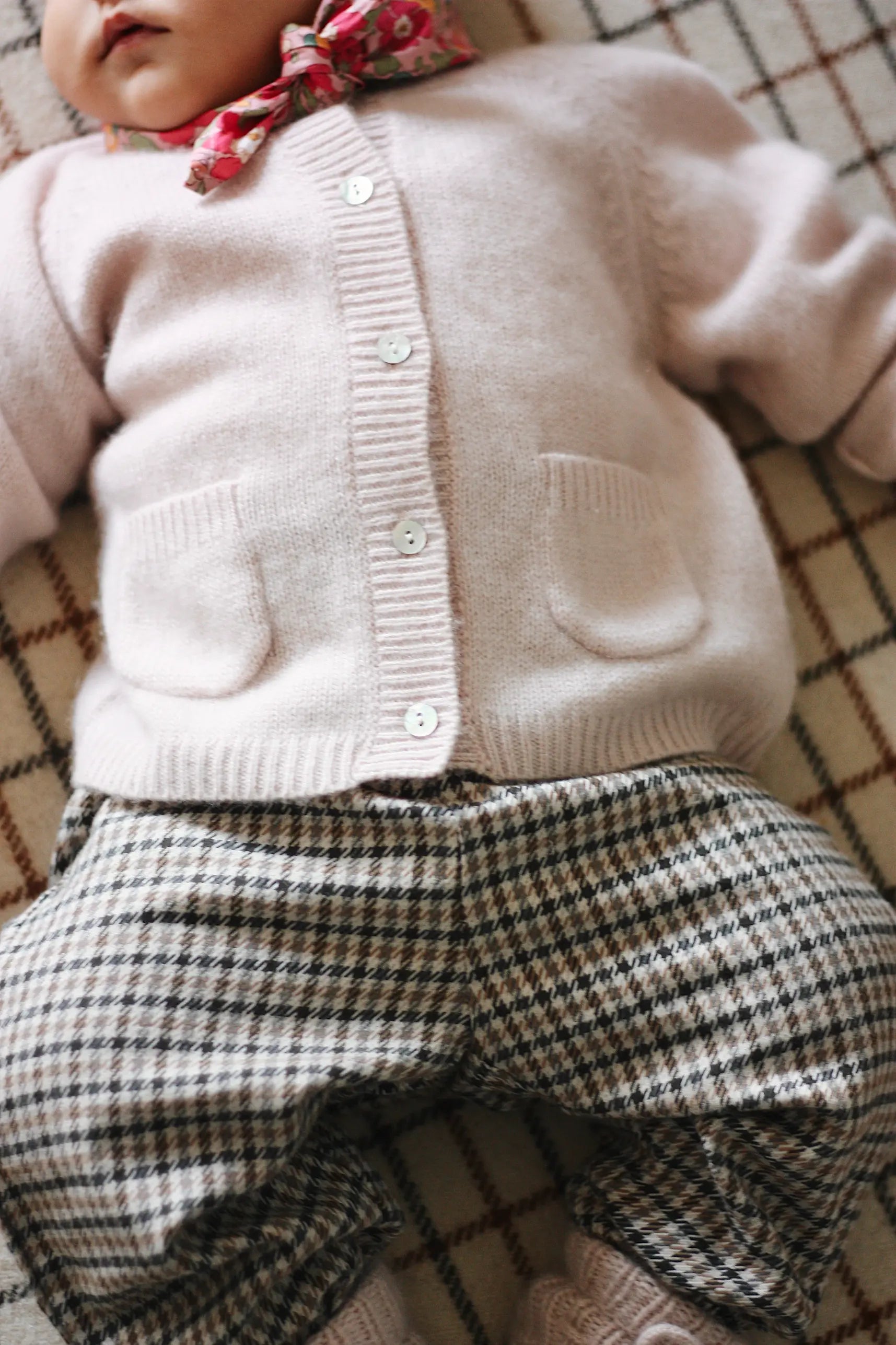 Baby girl wearing Lalaby Pixi pants in tweedy check organic cotton