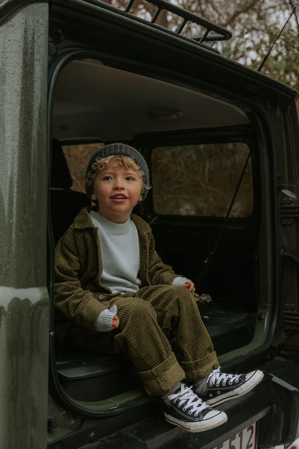 Boy wearing Lalaby Samson kids shirt in forest green organic cotton mega cord