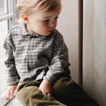 Baby boy wearing Lalaby Saxo baby shirt in tweedy check organic cotton