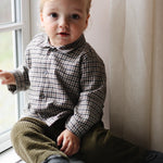 Baby boy wearing Lalaby Saxo baby shirt in tweedy check organic cotton