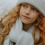 Girl wearing Lalaby Seal scarf and Woody beanie in bluey light blue cashmere