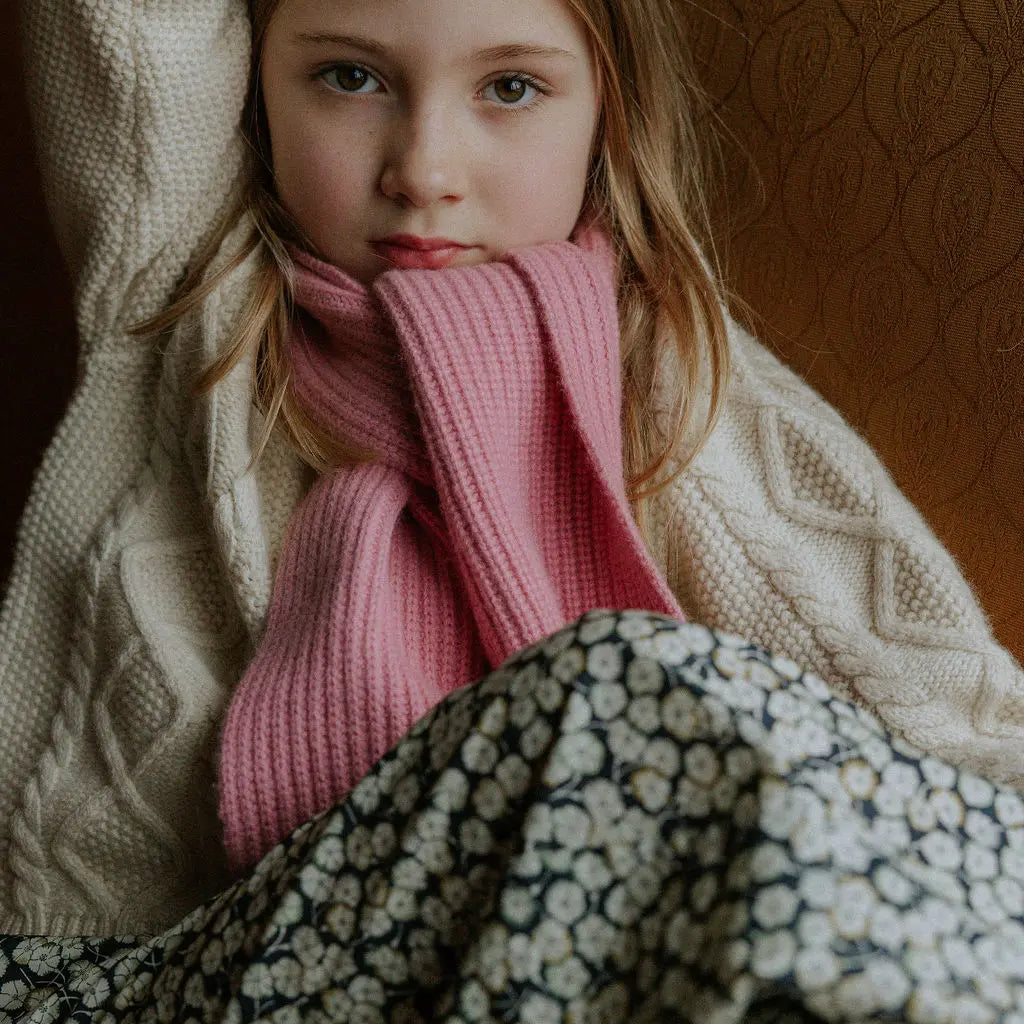 Girl wearing Lalaby Seal scarf in sorbet pink cashmere