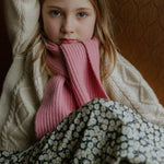 Girl wearing Lalaby Seal scarf in sorbet pink cashmere
