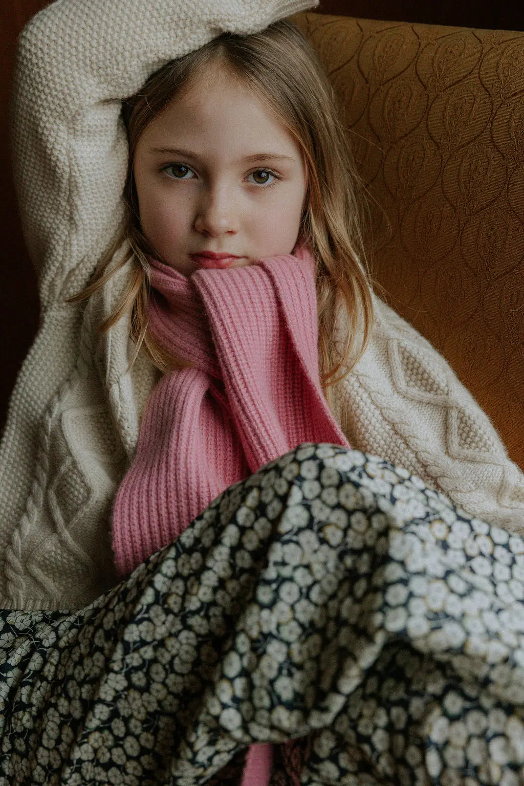 Girl wearing Lalaby Seal scarf in sorbet pink cashmere