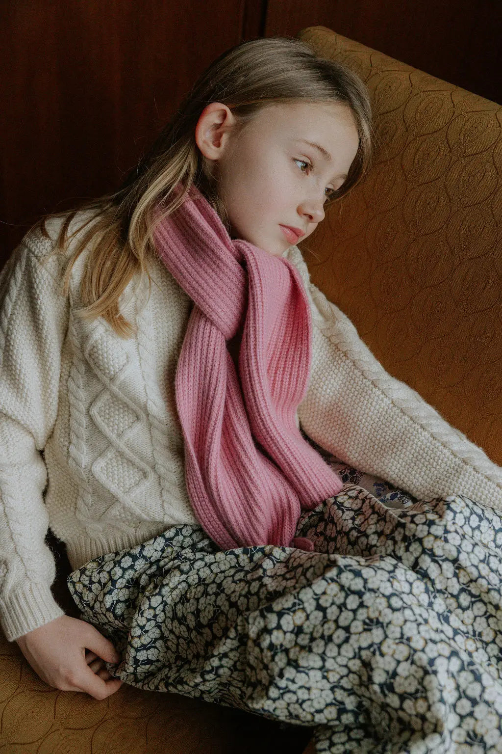 Girl wearing Lalaby Seal scarf in sorbet pink cashmere