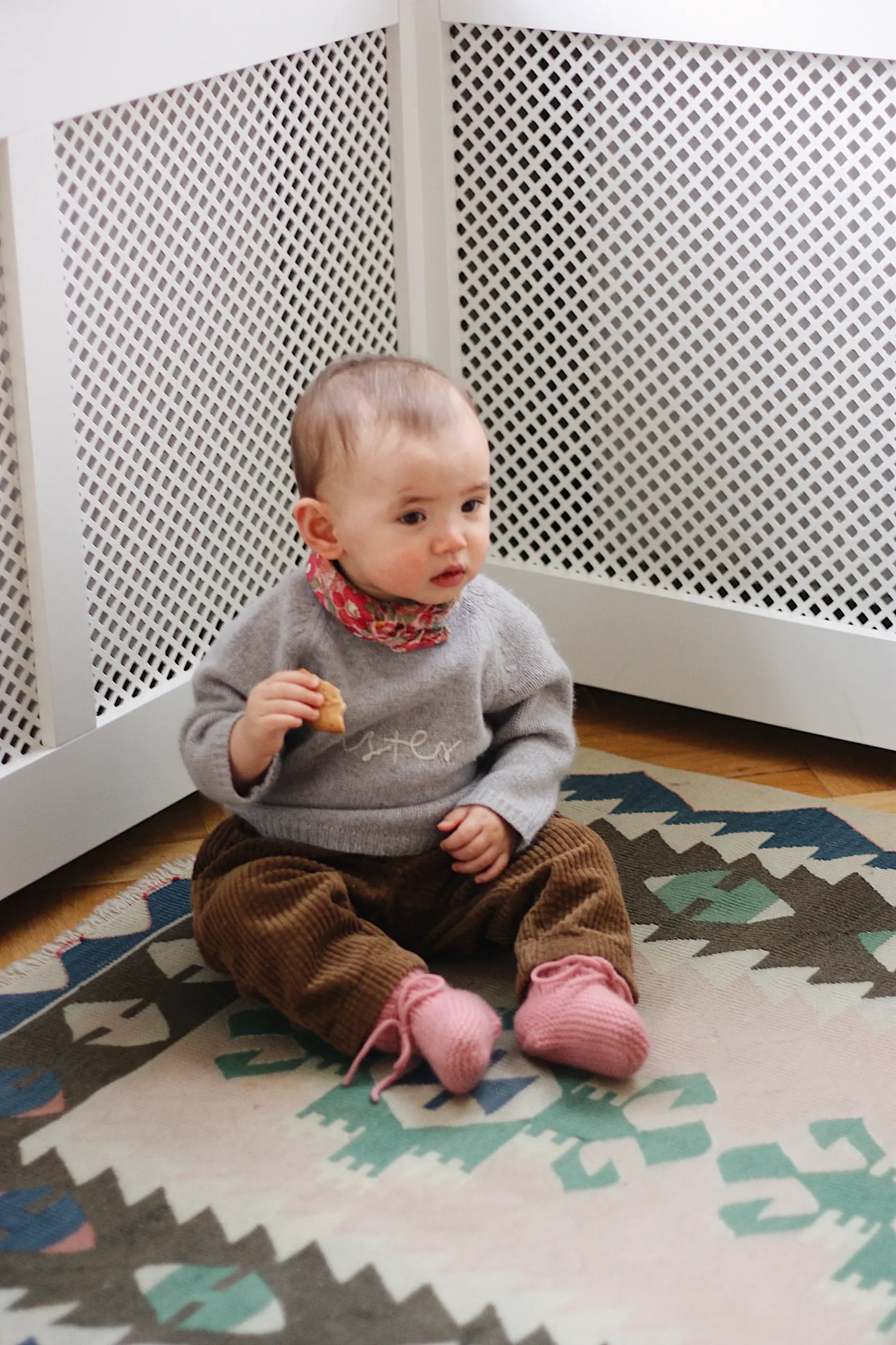 Baby girl wearing Lalaby Sister baby sweater in a grey baby wool, yak and cashmere blend