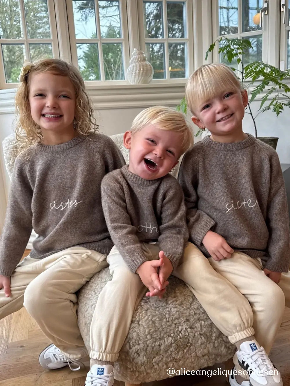 Siblings wearing wearing Lalaby Brother and Sister sweater for kids in a millet brown baby wool, yak and cashmere blend