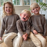 Siblings wearing wearing Lalaby Brother and Sister sweater for kids in a millet brown baby wool, yak and cashmere blend