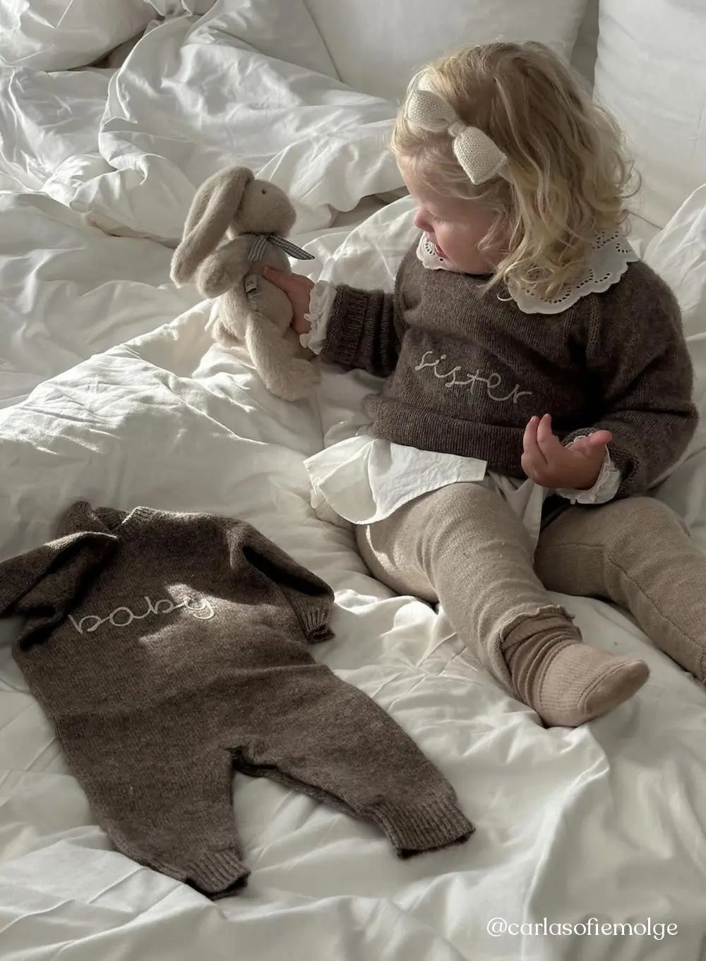 Girl wearing Lalaby Sister sweater for kids and a Aspen jumpsuit for babies in a millet brown baby wool, yak and cashmere blend