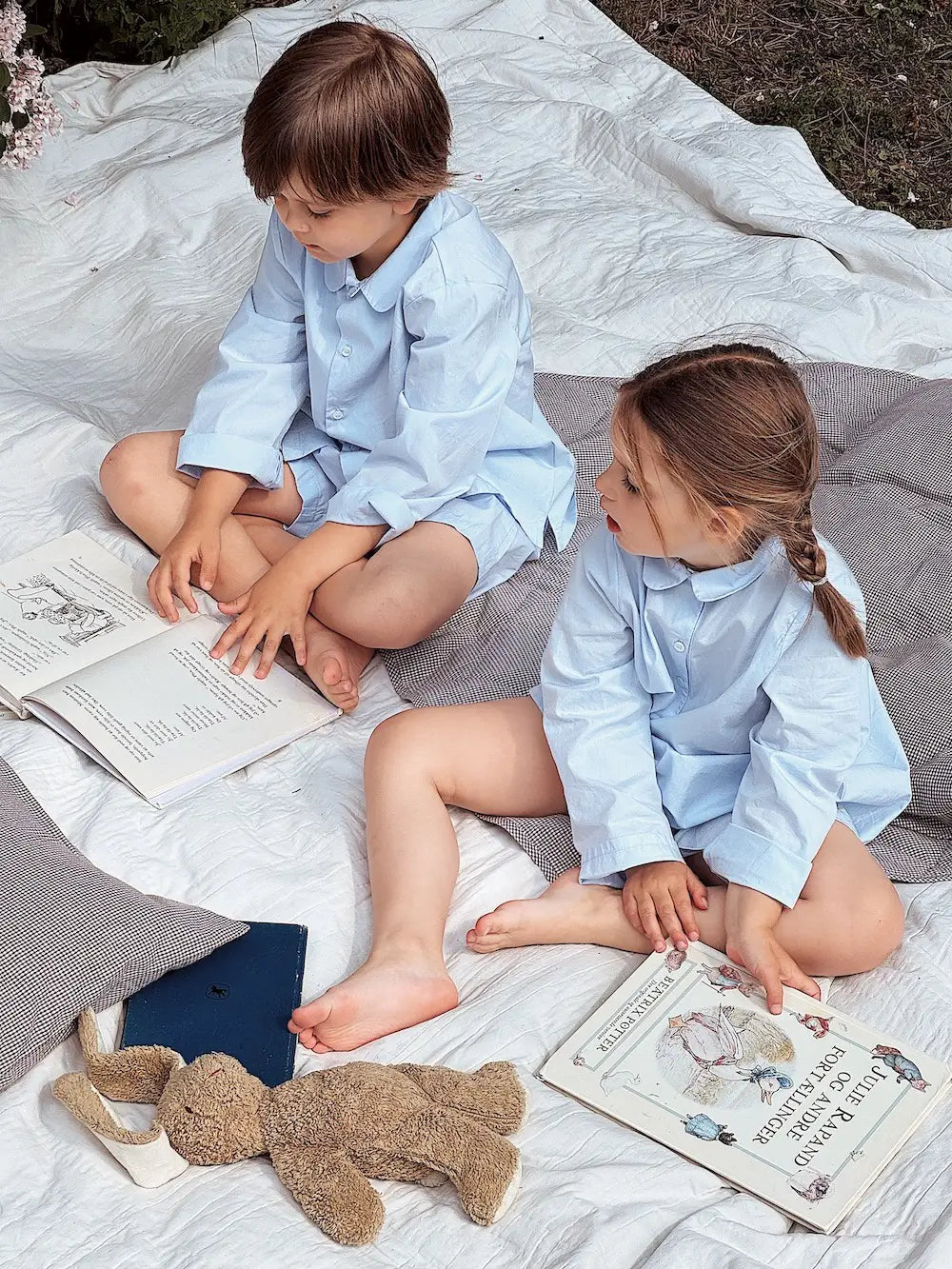 Boy and girl wearing Lalaby summer pyjamas and pj dress for kids in sky blue organic cotton