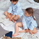 Boy and girl wearing Lalaby summer pyjamas and pj dress for kids in sky blue organic cotton