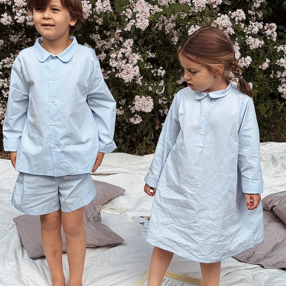 Boy and girl wearing Lalaby summer pyjamas and pj dress for kids in sky blue organic cotton