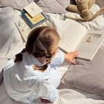 Girl wearing Lalaby summer pj dress for kids in sky blue organic cotton