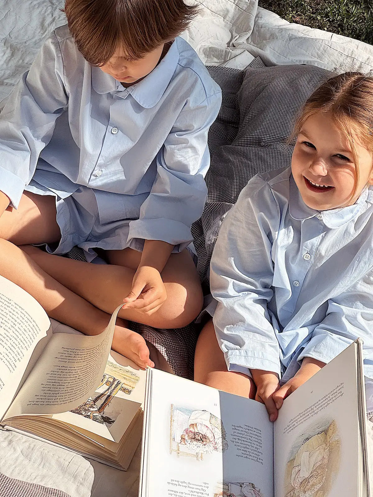 Boy and girl wearing Lalaby summer pyjamas and pj dress for kids in sky blue organic cotton