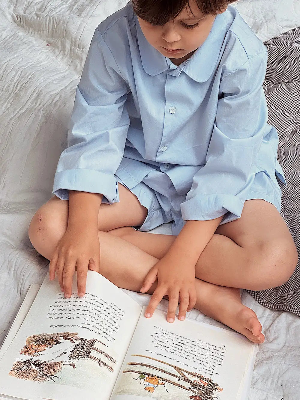 Boy wearing Lalaby summer pyjamas for kids in sky blue organic cotton